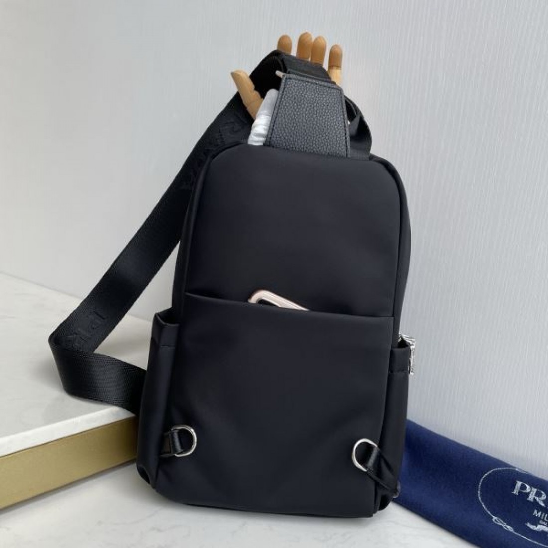 シンプル 高級感 PRADA プラダ コピー ボディバッグ ナイロン素材 縦型スリングバッグ ミニマルデザイン フロントロゴ 三角プレート 軽量設計 快適フィット