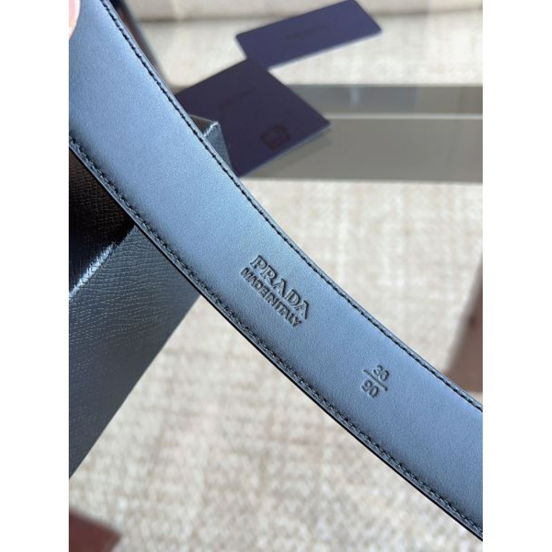 シャープ輪郭 Prada プラダ コピー ベルト ブラックレザー 細かなエンボス加工 サークルメタルバックル ロゴ刻印 都会的スタイル